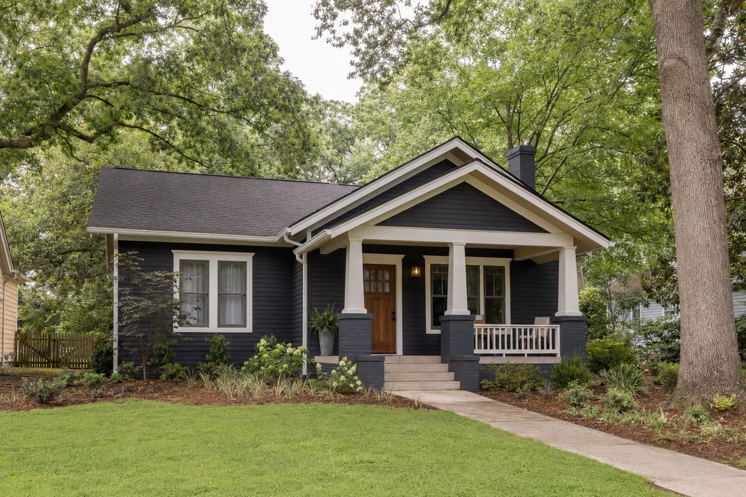 Dark-sided bungalow with a welcoming front porch